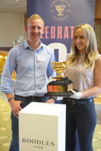 Matthew Marshall and Hannah Wait of Pi Accountancy with the Cheltenham Gold Cup 